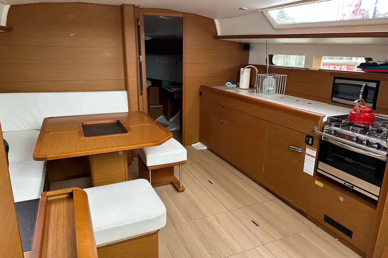  Yacht Photos Pics Interior of 2018 Jeanneau Sun Odyssey 479 yacht with modern kitchen and dining area.