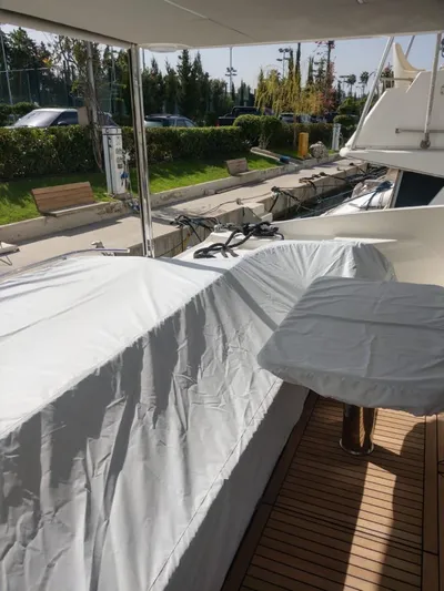  Yacht Photos Pics Covered deck area of a 2020 Absolute 50 Fly yacht docked at a marina.