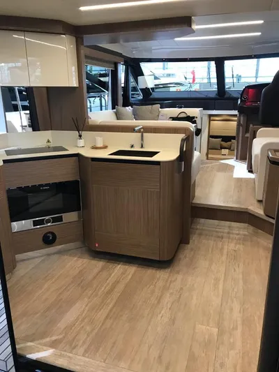  Yacht Photos Pics Interior of a 2020 Absolute 50 Fly yacht with modern kitchen and seating area.