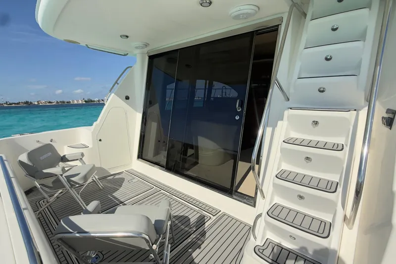 Rubicon Yacht Photos Pics 2008 Meridian 580 Pilothouse yacht deck with chairs, stairs, and ocean view.