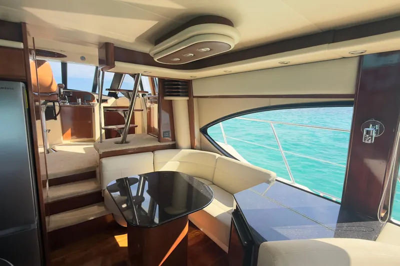 Rubicon Yacht Photos Pics Luxurious interior of 2008 Meridian 580 Pilothouse yacht with elegant seating and ocean view.