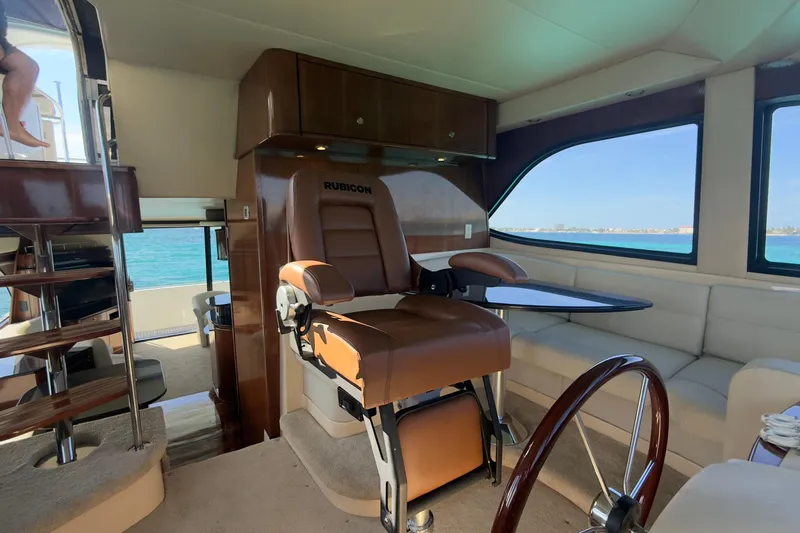 Rubicon Yacht Photos Pics Luxurious interior of 2008 Meridian 580 Pilothouse yacht with captain's chair and ocean view.