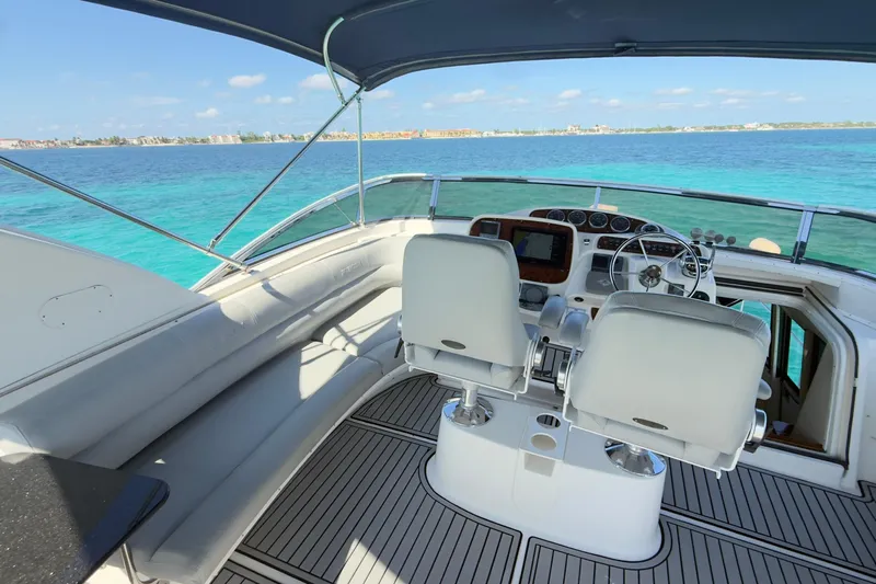 Rubicon Yacht Photos Pics 2008 Meridian 580 Pilothouse yacht interior with helm, overlooking clear blue ocean waters.