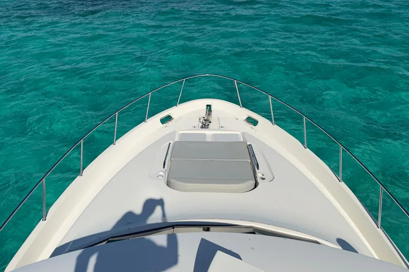 Rubicon Yacht Photos Pics Bow view of 2008 Meridian 580 Pilothouse on clear turquoise water.