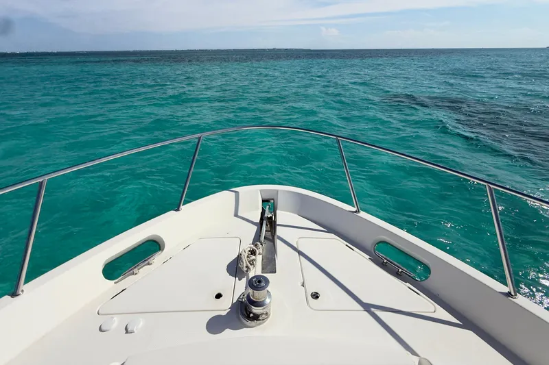 Rubicon Yacht Photos Pics Bow view of 2008 Meridian 580 Pilothouse on turquoise ocean waters.