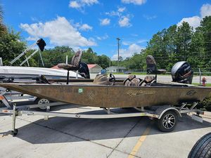 2022 G3 Sportsman 1710 boat on trailer, outdoors under blue sky.
