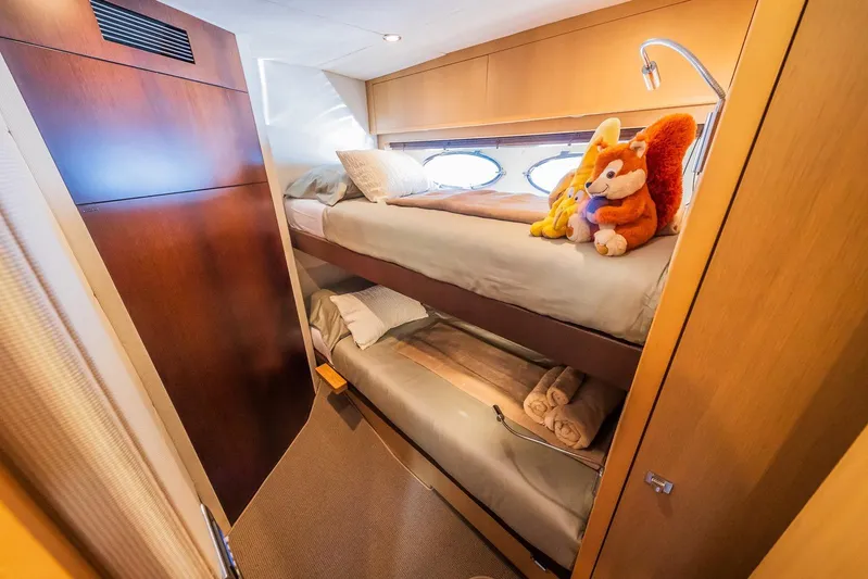 Gitana II Yacht Photos Pics Cozy bunk beds in 2009 Princess V78 yacht cabin with plush toys and soft lighting.