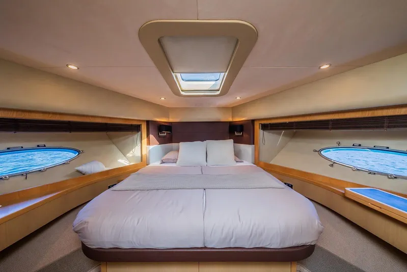 Gitana II Yacht Photos Pics Luxurious bedroom interior of 2009 Princess V78 yacht with skylight and ocean view.