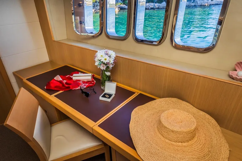 Gitana II Yacht Photos Pics Luxurious interior of 2009 Princess V78 yacht with window view, hat, and flowers.