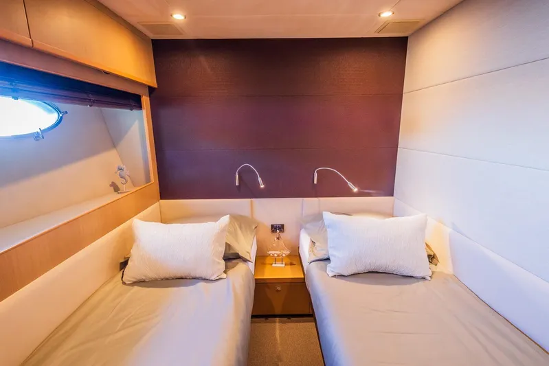 Gitana II Yacht Photos Pics Luxurious twin cabin interior on 2009 Princess V78 yacht, featuring modern design and cozy bedding.