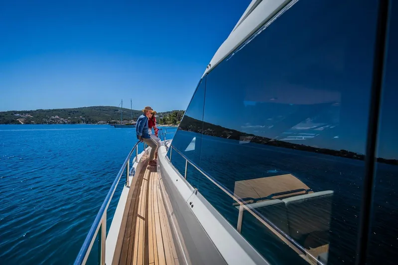 Gitana II Yacht Photos Pics 2009 Princess V78 yacht cruising on clear blue waters under a sunny sky.