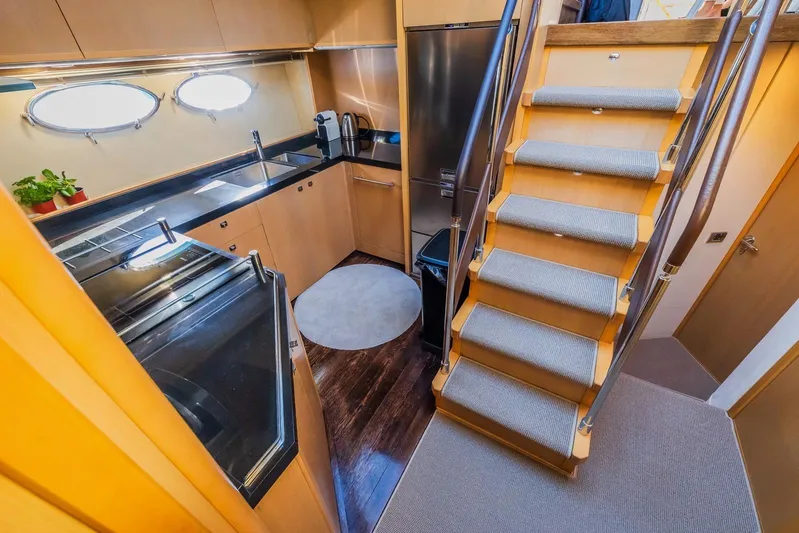 Gitana II Yacht Photos Pics Luxurious 2009 Princess V78 yacht interior with modern kitchen and stylish staircase.
