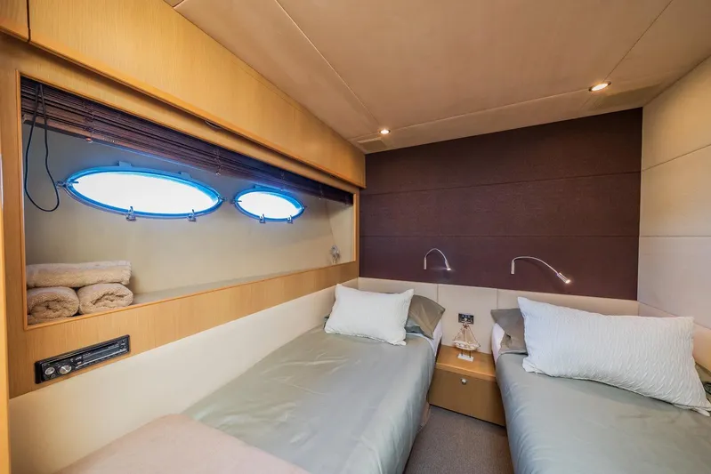 Gitana II Yacht Photos Pics Luxurious twin cabin interior on 2009 Princess V78 yacht with modern design and porthole windows.