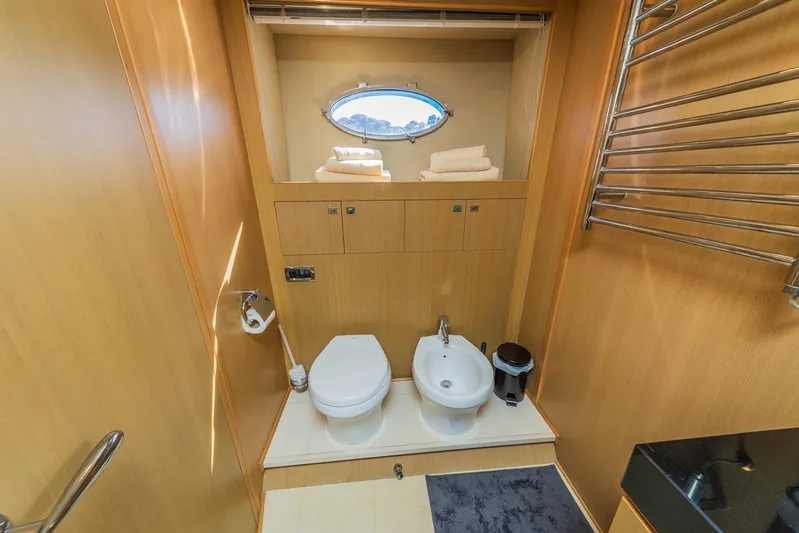 Gitana II Yacht Photos Pics Luxurious bathroom on 2009 Princess V78 yacht with toilet, bidet, and towel storage.