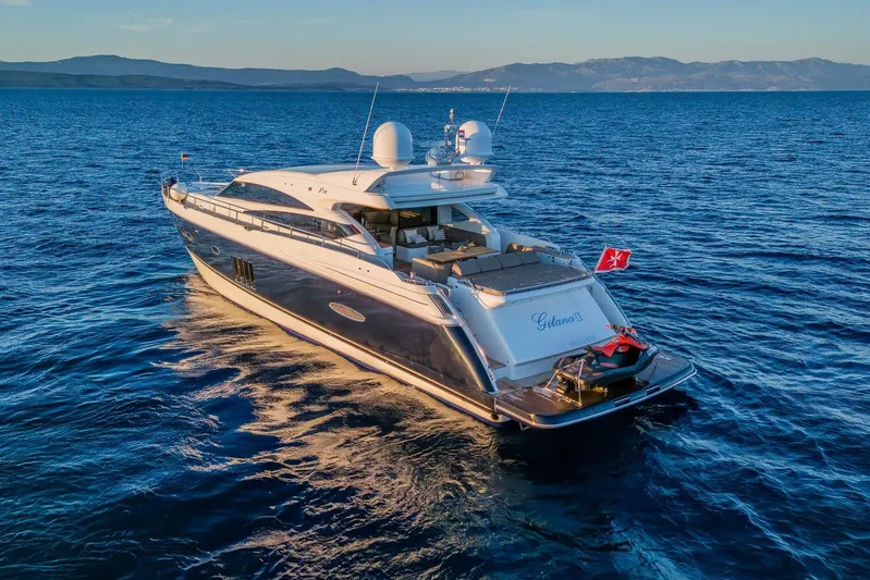 Gitana II Yacht Photos Pics Luxurious 2009 Princess V78 yacht cruising on serene blue waters at sunset.
