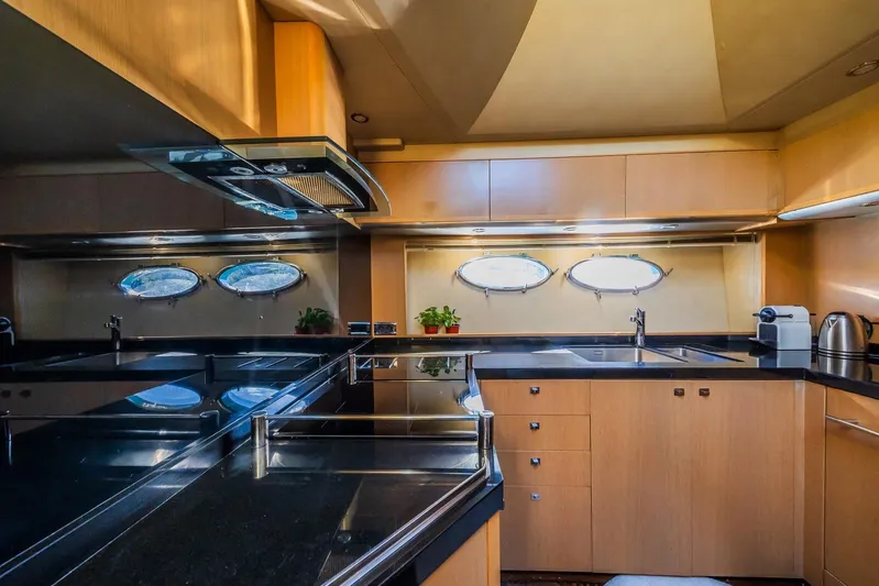 Gitana II Yacht Photos Pics Luxurious kitchen interior of 2009 Princess V78 yacht with modern appliances and sleek design.