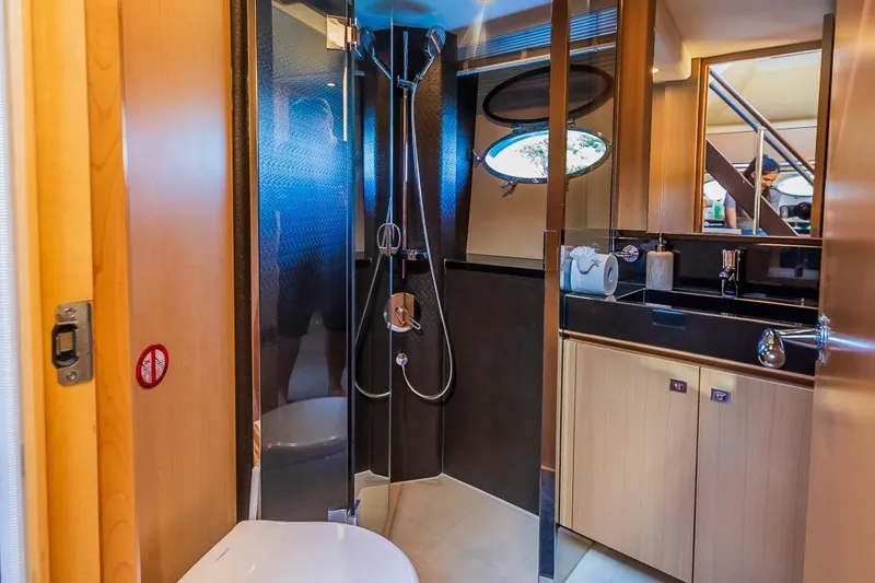 Gitana II Yacht Photos Pics Luxurious bathroom interior of 2009 Princess V78 yacht with modern fixtures and wood accents.