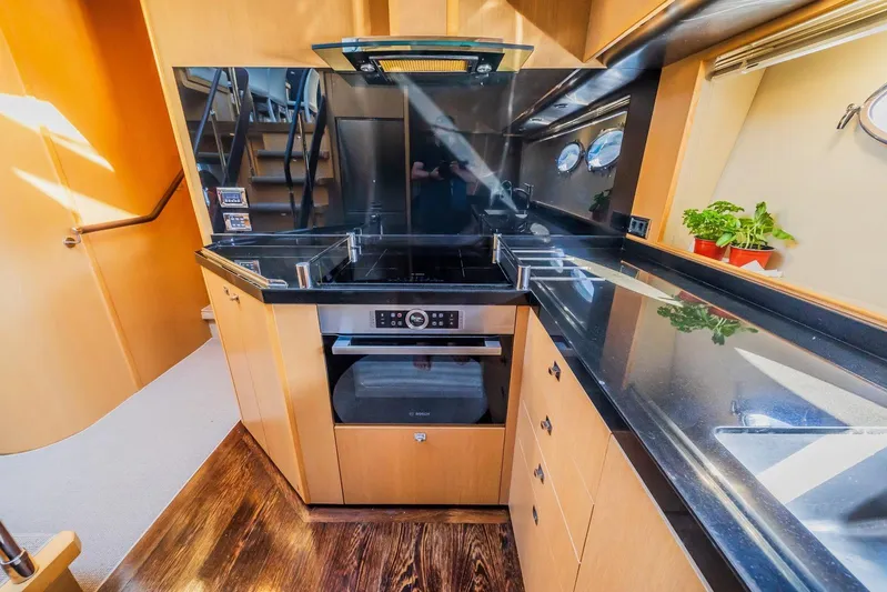 Gitana II Yacht Photos Pics Luxurious kitchen interior of 2009 Princess V78 yacht with modern appliances and sleek design.
