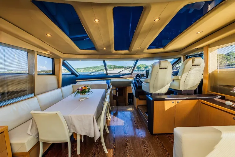 Gitana II Yacht Photos Pics Luxurious interior of 2009 Princess V78 yacht with elegant dining area and helm station.