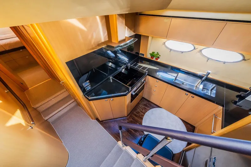 Gitana II Yacht Photos Pics Luxurious kitchen interior of 2009 Princess V78 yacht with modern appliances and sleek design.