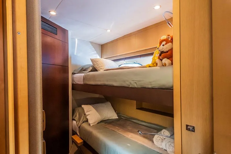 Gitana II Yacht Photos Pics Cozy bunk beds in 2009 Princess V78 yacht cabin with plush toys and soft lighting.