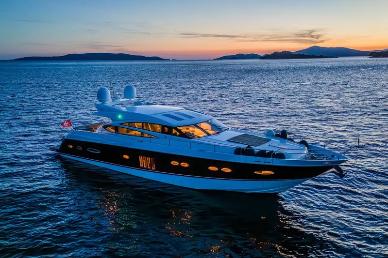 Gitana II Yacht Photos Pics Luxurious 2009 Princess V78 yacht cruising at sunset on serene waters.