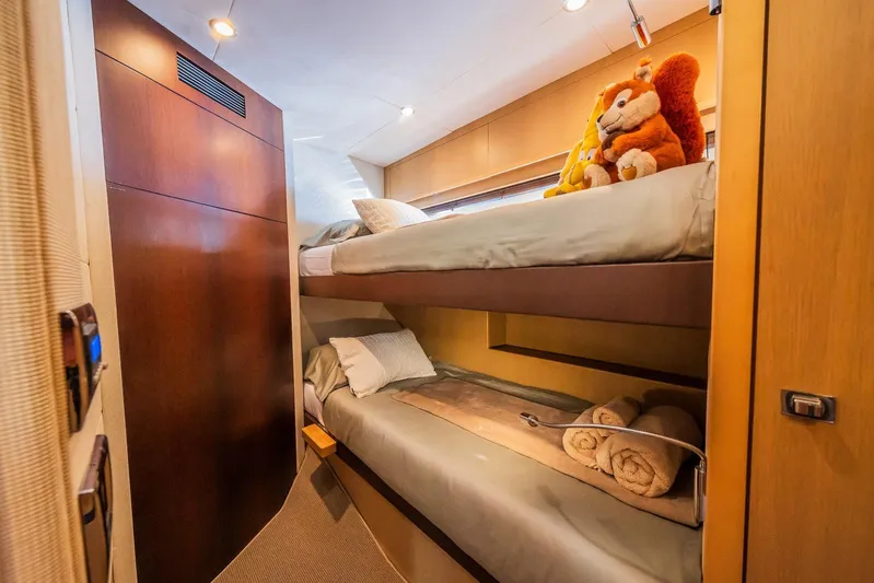 Gitana II Yacht Photos Pics Bunk beds in 2009 Princess V78 yacht cabin with plush toys and rolled towels.