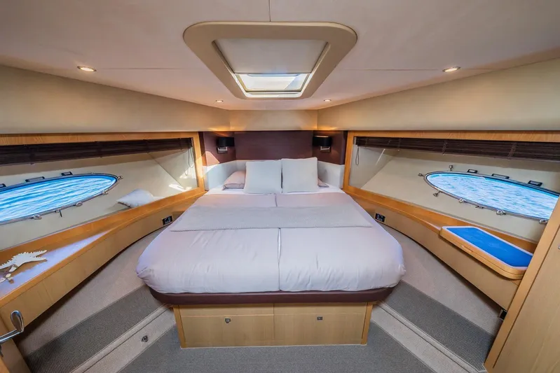 Gitana II Yacht Photos Pics Luxurious bedroom interior of 2009 Princess V78 yacht with skylight and ocean view.