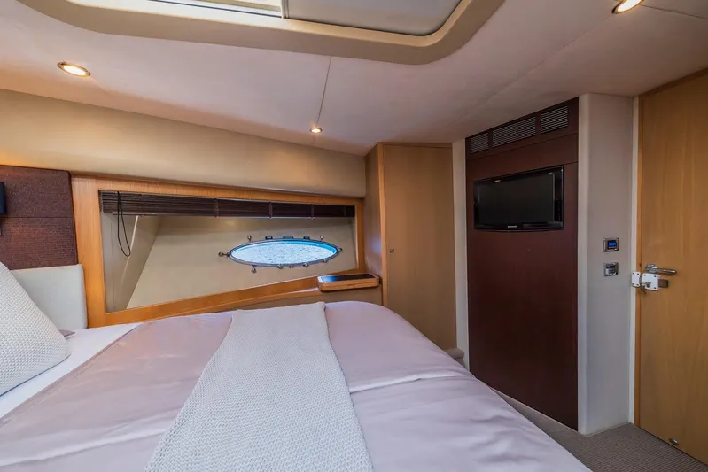 Gitana II Yacht Photos Pics Luxurious bedroom interior of 2009 Princess V78 yacht with modern amenities.