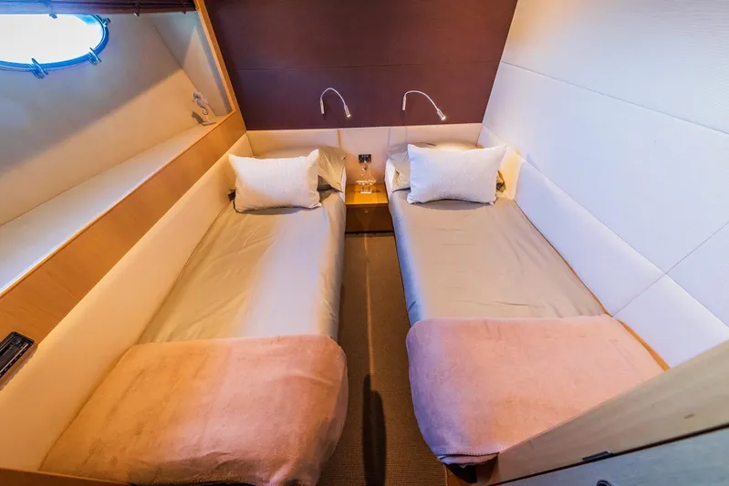 Gitana II Yacht Photos Pics Twin cabin interior of 2009 Princess V78 yacht with modern design and cozy bedding.