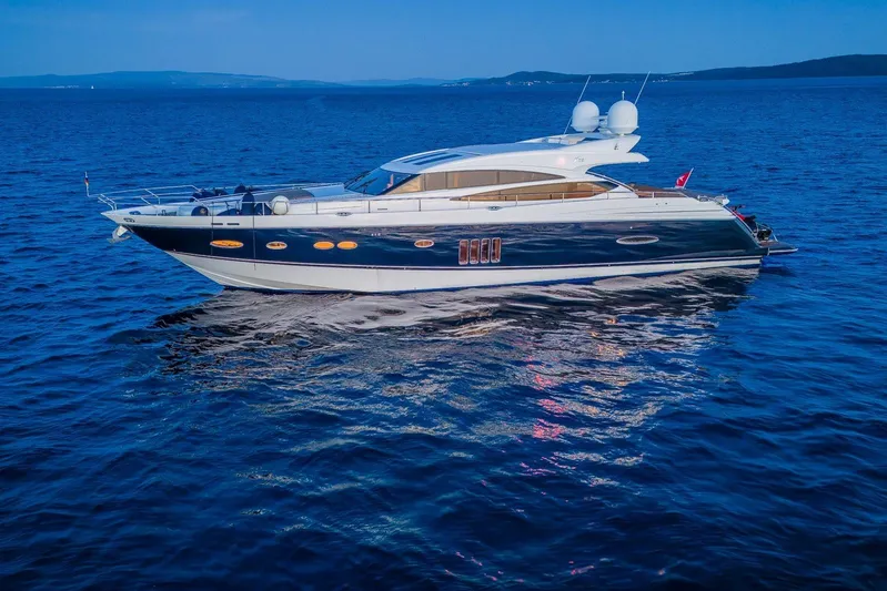 Gitana II Yacht Photos Pics Luxurious 2009 Princess V78 yacht cruising on calm blue waters.