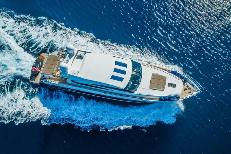 Gitana II Yacht Photos Pics Aerial view of 2009 Princess V78 yacht cruising on blue ocean waters.