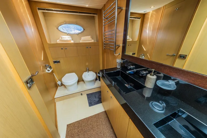 Gitana II Yacht Photos Pics Luxurious bathroom in 2009 Princess V78 yacht with modern fixtures and wooden cabinetry.