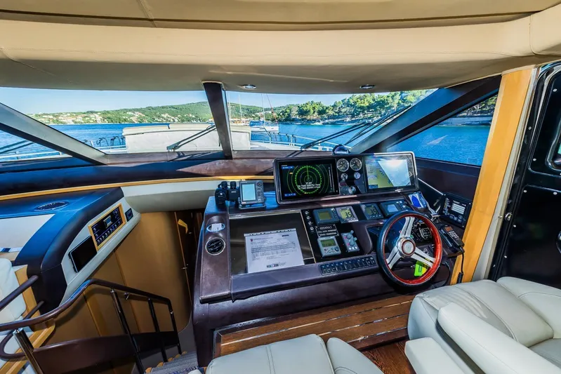 Gitana II Yacht Photos Pics Luxurious 2009 Princess V78 yacht cockpit with advanced navigation systems and scenic ocean view.