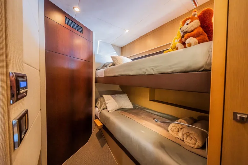 Gitana II Yacht Photos Pics Cozy bunk beds in 2009 Princess V78 yacht cabin with plush toys and warm lighting.