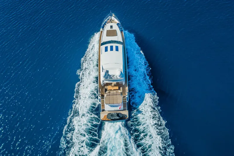 Gitana II Yacht Photos Pics Aerial view of 2009 Princess V78 yacht cruising on open blue sea.