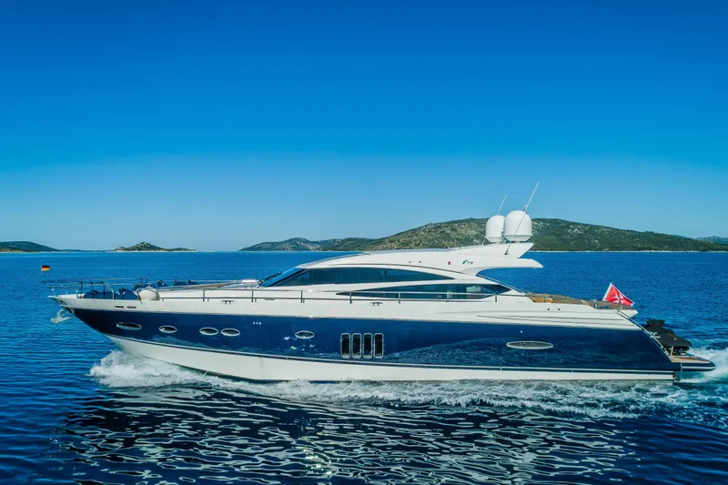Gitana II Yacht Photos Pics Luxurious 2009 Princess V78 yacht cruising on clear blue waters.