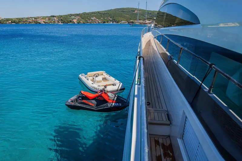 Gitana II Yacht Photos Pics Luxury yacht Princess V78 with jet ski and tender in clear blue waters, 2009 model.