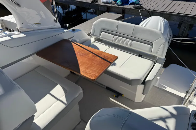  Yacht Photos Pics 2024 Regal 26 XO boat interior with white seating and wooden table.