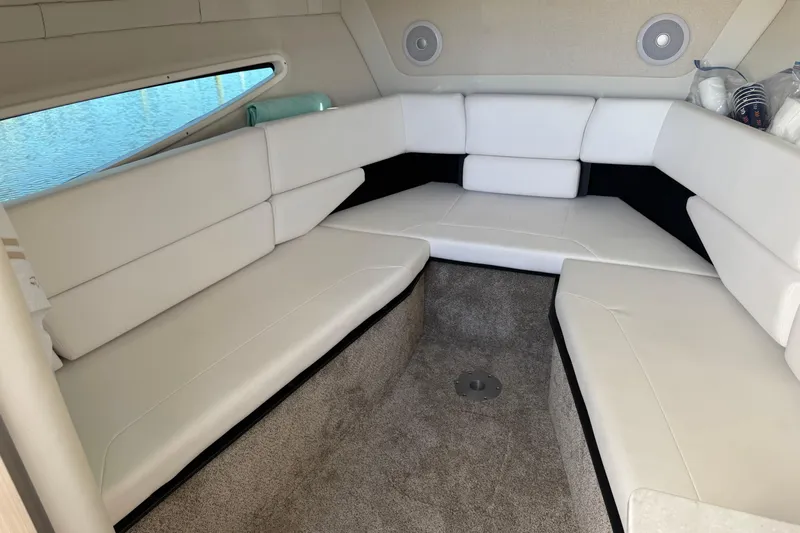  Yacht Photos Pics 2024 Regal 26 XO boat interior with white seating and carpeted floor.