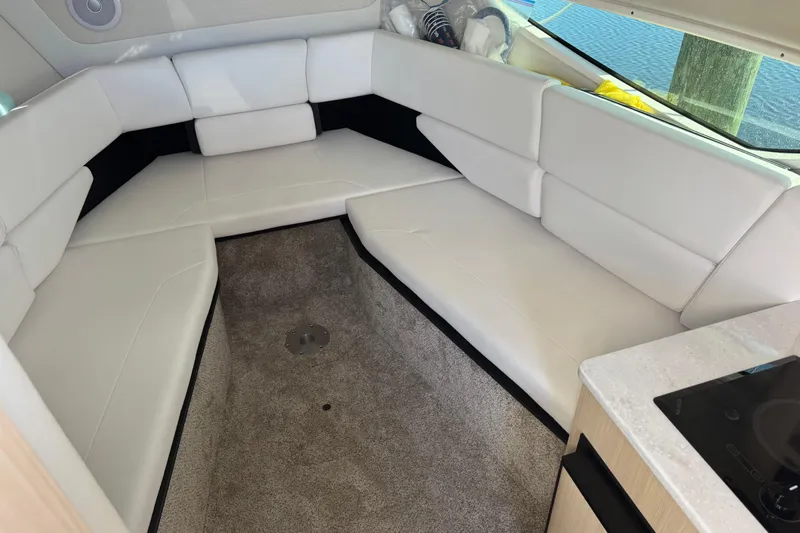  Yacht Photos Pics 2024 Regal 26 XO boat interior with white seating and carpeted floor.