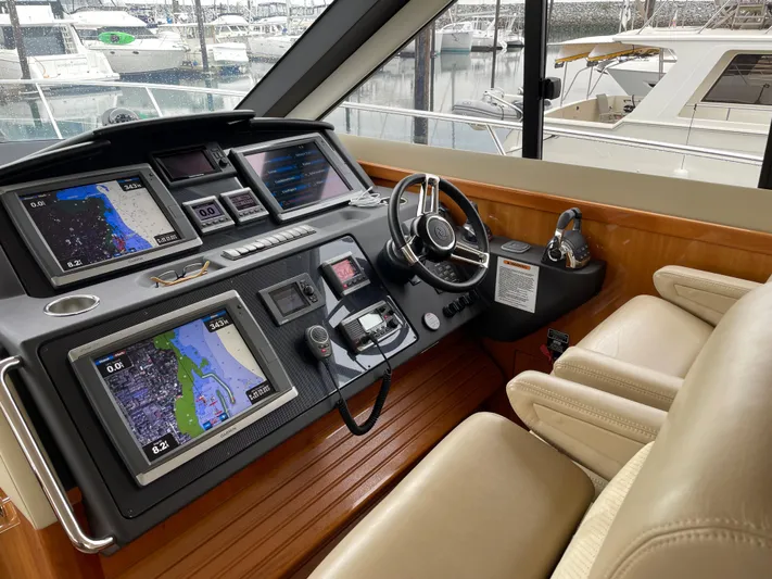 Phantom Of The Sea Yacht Photos Pics 2013 Riviera 5800 Sport Yacht helm with navigation screens and leather seating.