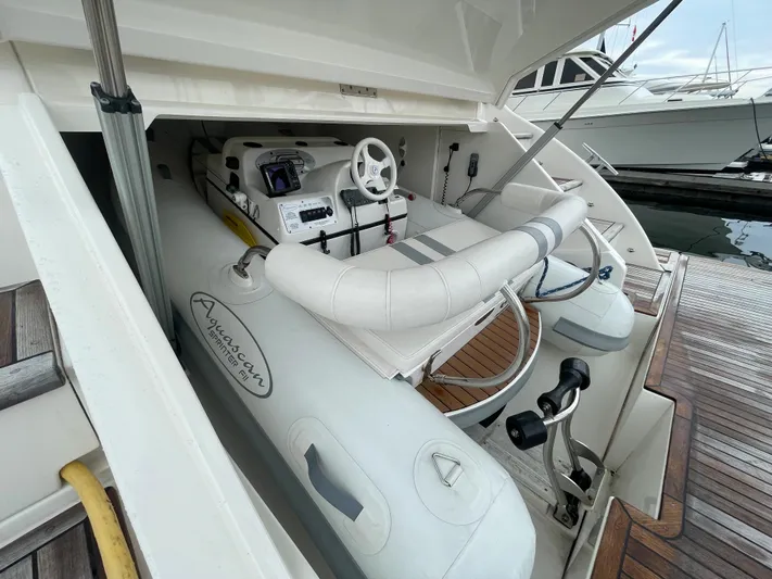 Phantom Of The Sea Yacht Photos Pics 2013 Riviera 5800 Sport Yacht with inflatable tender in storage compartment at marina.