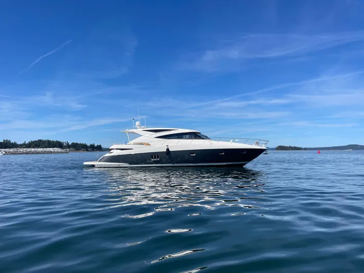 Phantom Of The Sea Yacht Photos Pics 2013 Riviera 5800 Sport Yacht on calm blue water under clear sky.
