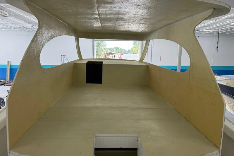 No Name Yacht Photos Pics 2025 Xcelerator Walk Around boat interior under construction in a workshop.