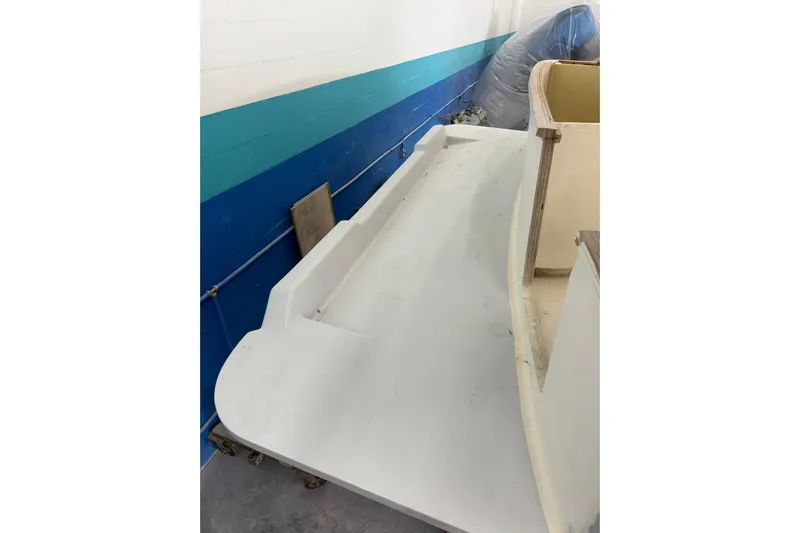 No Name Yacht Photos Pics 2025 Xcelerator Walk Around boat deck under construction in a workshop.