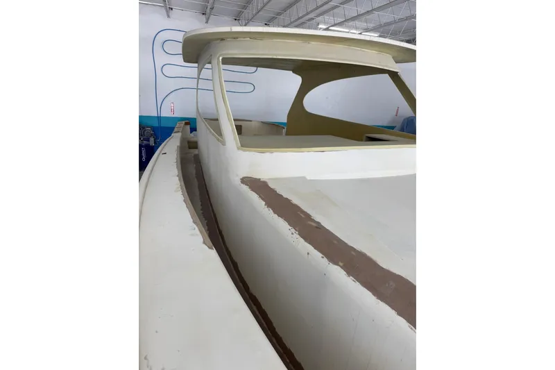 No Name Yacht Photos Pics 2025 Xcelerator Walk Around boat under construction in a workshop.