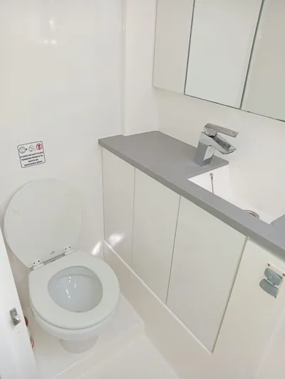 Marylee Yacht Photos Pics Modern bathroom in a 2020 Leopard 45 yacht with toilet and sink.