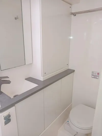 Marylee Yacht Photos Pics Modern bathroom in a 2020 Leopard 45 yacht with sink, mirror, and toilet.