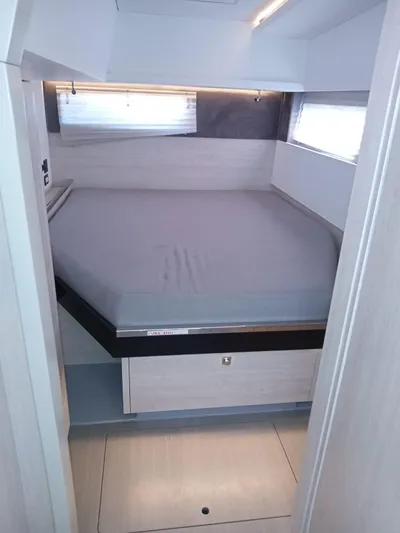 Marylee Yacht Photos Pics Modern bedroom interior of a 2020 Leopard 45 catamaran with a cozy bed.